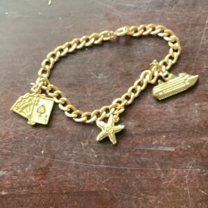 Gold tone Charm Bracelet with Star and ship and cards
